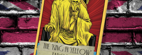 The King in Yellow tarot deck by Arc Dream Publishing in front of a brick wall painted in the red, white, and blue of the UK flag.